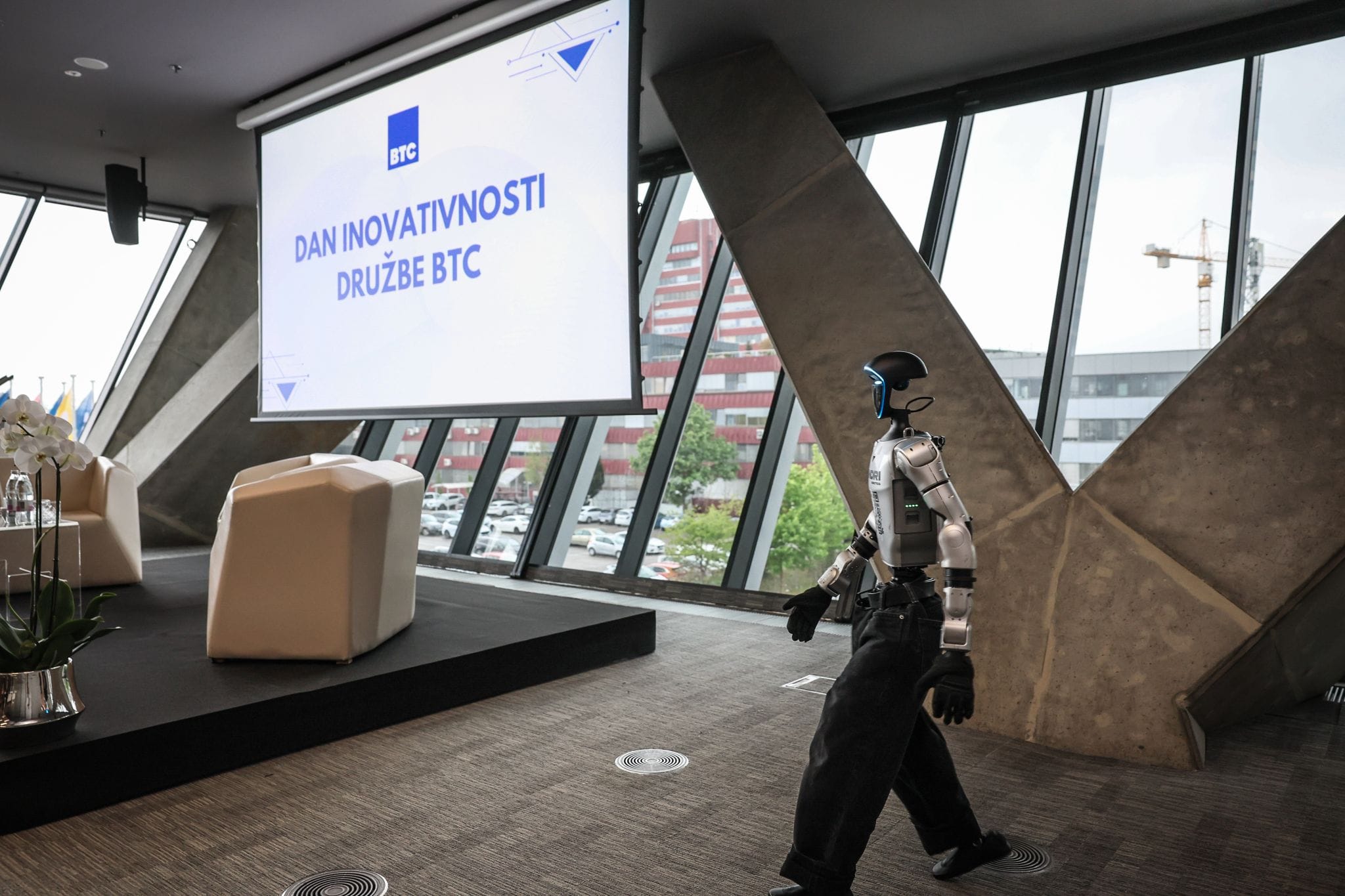 Humanoid robot Jože walking across the stage at BTC Day of Innovation 2026