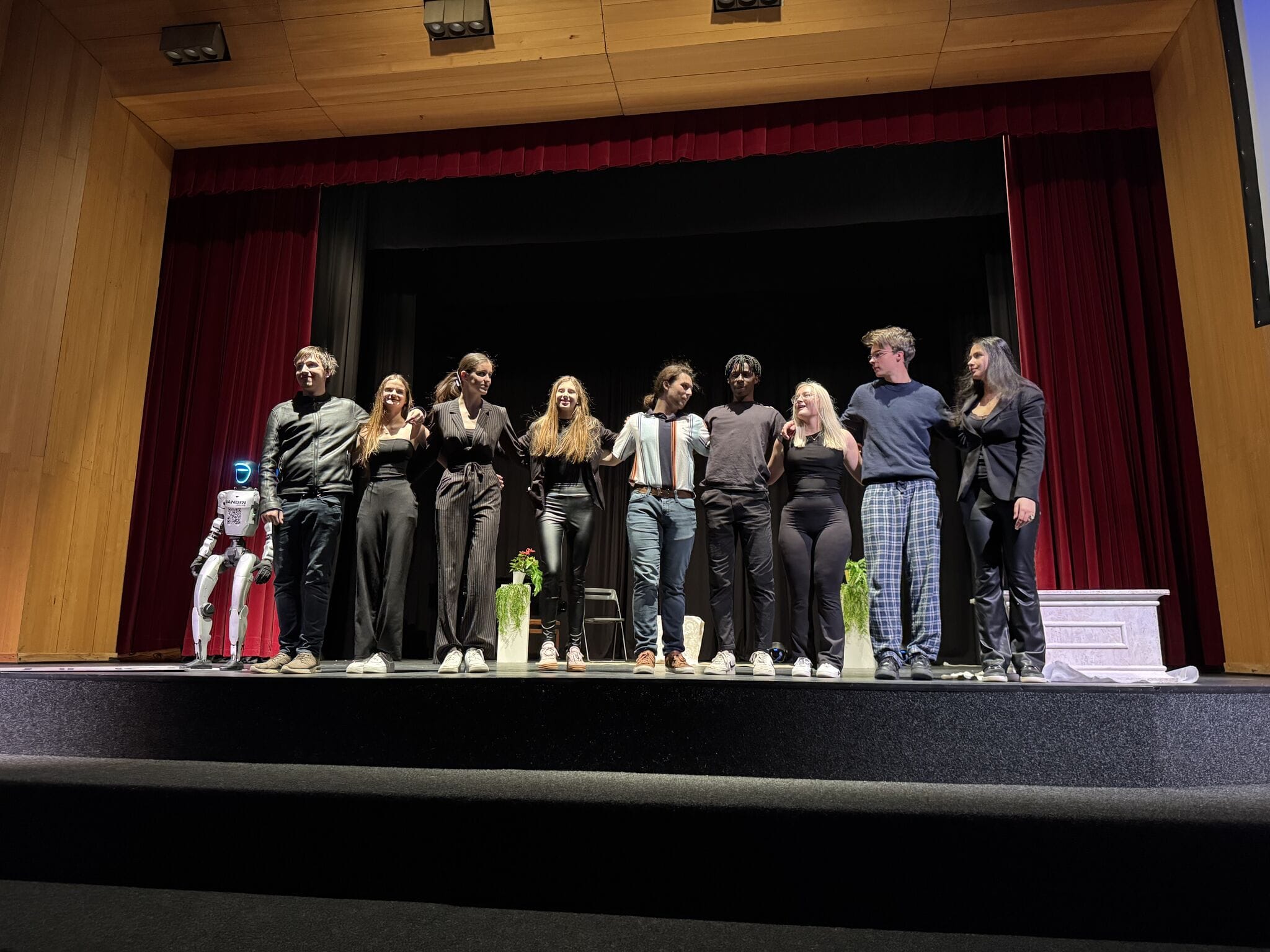 Curtain call with the cast and the humanoid robot