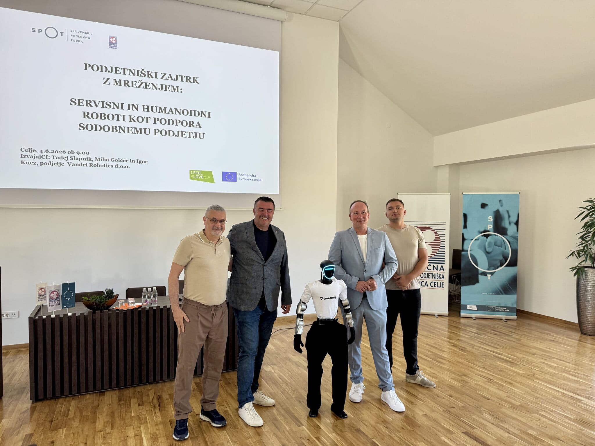 Vandri Robotics team with hosts and humanoid robot Jože at the Celje Chamber of Craft and Small Business
