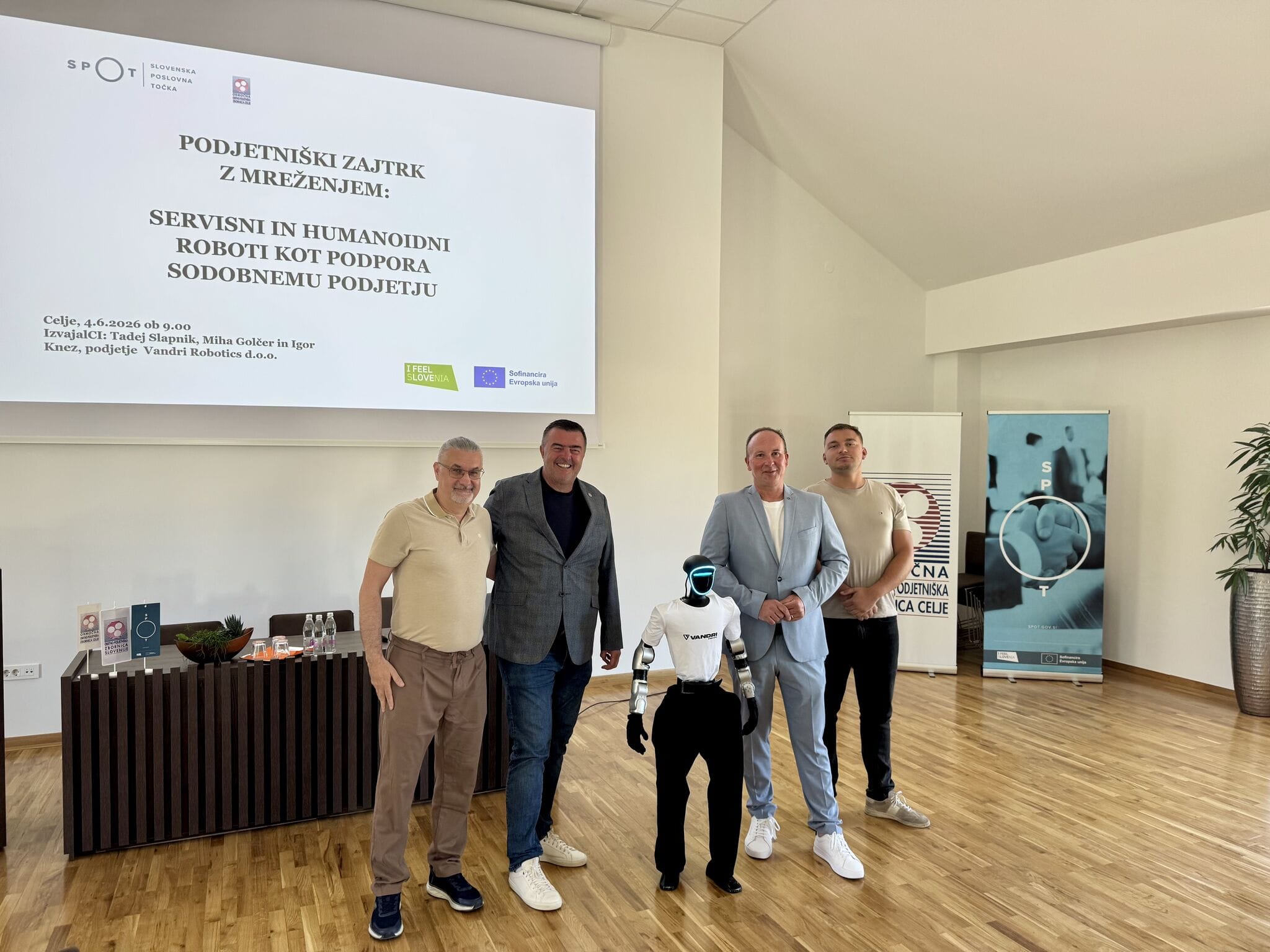 Vandri Robotics team with hosts and humanoid robot Jože at the Celje Chamber of Craft and Small Business